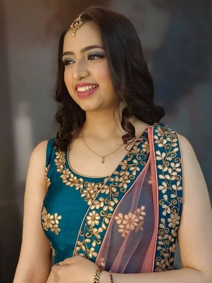 A lovely smiling shot that shows off her natural-looking glam. The makeup enhances her features without overpowering them.