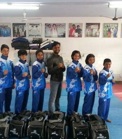 My team of young fighters ready for training with their gear. We provide a structured environment where kids learn discipline and respect.