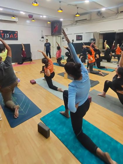 A wide shot of our progressive Ashtanga workshop in Mumbai. The energy of a group practicing together is palpable, creating a supportive atmosphere for growth and exploration.