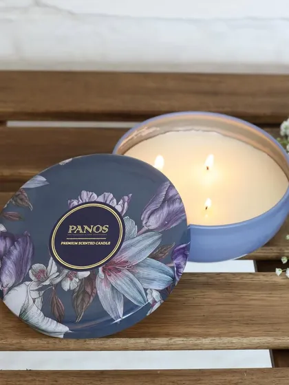 A large, three-wick scented candle in a tin with a beautiful floral design. It’s perfect for creating a powerful and long-lasting fragrance experience in larger spaces.