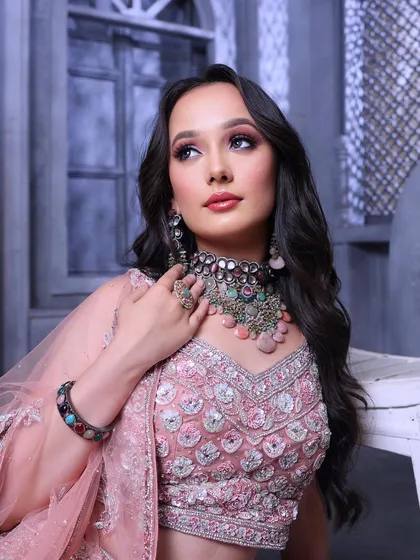 A dreamy and romantic portrait. The makeup is soft and ethereal, perfectly matching the pastel tones of the outfit.