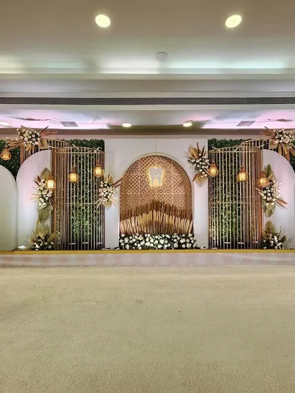 A full view of a beautiful boho-themed stage. The design incorporates natural textures, pampas grass, and intricate lattice work to create a look that is both earthy and elegant.
