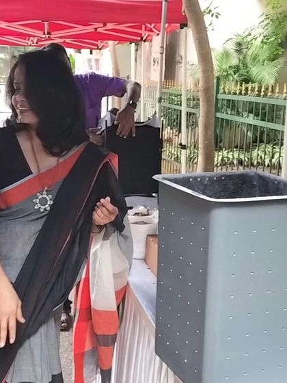 A candid moment at my stall. I love interacting with people and explaining how my composters, like the sleek grey EVA inner shell shown here, can help them start their sustainability journey.