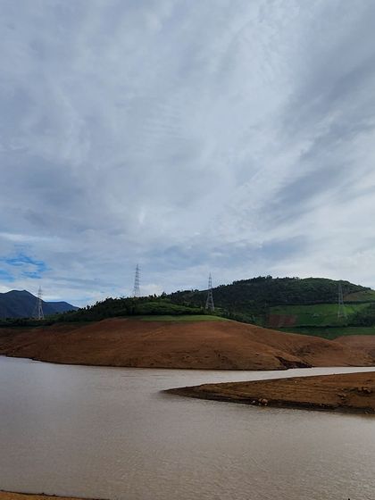 The calm waters of a reservoir against the backdrop of rolling hills. A peaceful scene from one of our getaways.