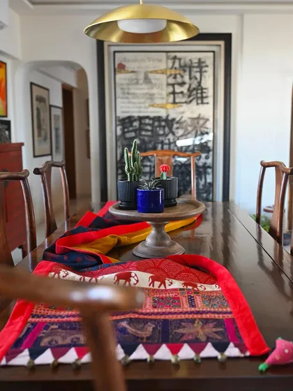 A beautifully composed shot of the Banjara runner on a dining table, with the intricate embroidery in the foreground.