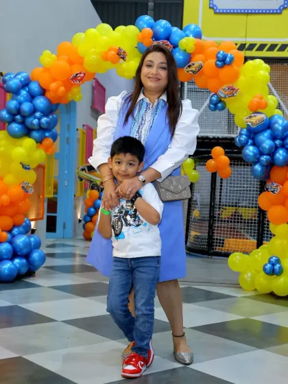 A mother and son share a special moment at a Hot Wheels themed birthday party.