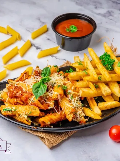A hearty plate of Marinara Pasta served with a side of crispy Jamaican-spiced fries. This combination offers a zesty and flavourful meal that's both satisfying and unique.