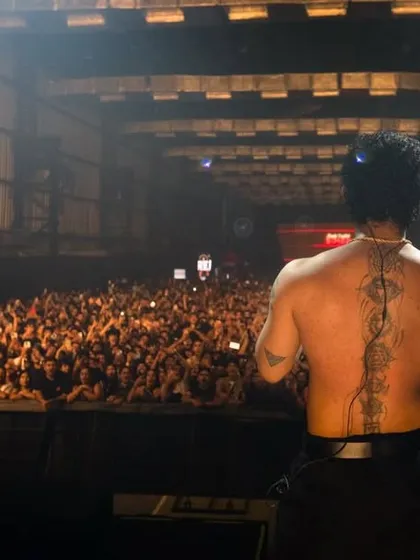 A moment of connection between artist and audience. Hanumankind looks out over a sea of fans, a powerful shot from one of his sold-out shows.