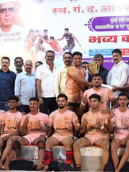 Receiving the winner's trophy from the organizers, a proud moment for the club.