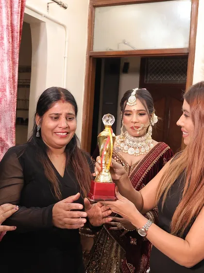 Handing over a trophy to a deserving student on portfolio day. Recognizing talent is so important.