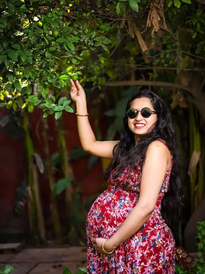 Maternity photos can be fun and playful too. We encouraged a spontaneous moment in the garden, with the mother-to-be interacting with her surroundings. This shot shows a different side of pregnancy, full of life and vibrant energy.
