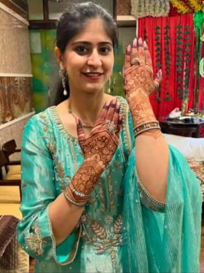 Another pose from a satisfied client. She's showing the beautiful details on the back of her hands, a design perfect for any special occasion.