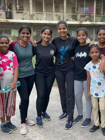 Some of the young girls from our November 2023 free training camp, smiling together after a session. Our goal is to create a safe and empowering space where girls can build confidence and friendship through martial arts.