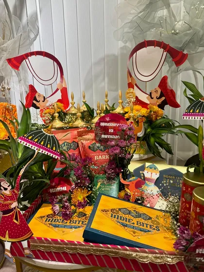 A vibrant and colorful Rakhi trousseau platter. This is perfect for a bride-to-be, featuring a mix of traditional Rajasthani decor and modern snacks.