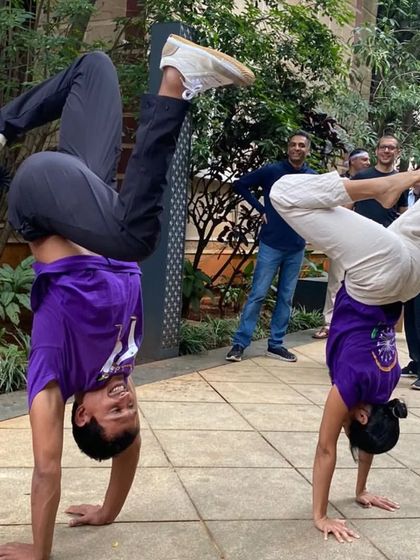 Instructors demonstrating handstand variations for kids. We make learning acrobatics fun and accessible for our youngest students.