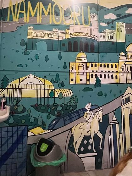 A "Namma Bengaluru" themed wall painting for a local eatery, featuring iconic city landmarks like Vidhana Soudha and Lalbagh Glass House.