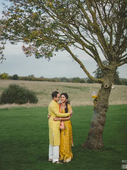 An intimate moment between the couple under a tree in the English countryside. Our planning allows for these quiet, romantic moments amidst the celebration.