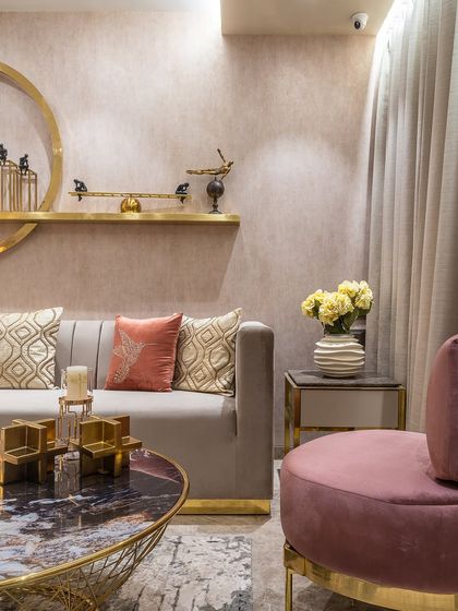 A close-up of a cozy corner in one of our projects. The combination of a pink occasional chair, a marble-topped coffee table, and soft textures creates a space that feels both luxurious and inviting.