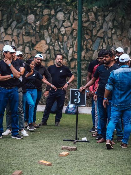 A team listens intently to instructions for a brick-walking challenge, another one of my unique team building exercises.
