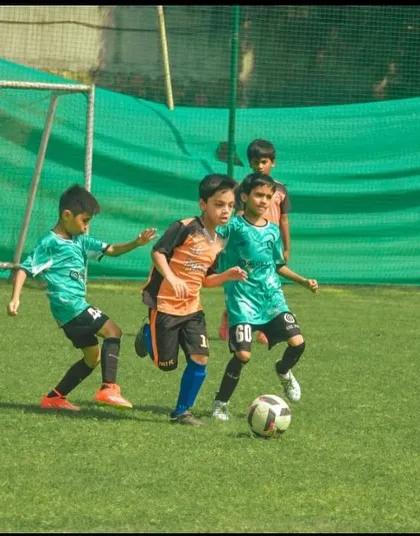 Our U9 players swarm the ball, demonstrating energetic and collective defending.