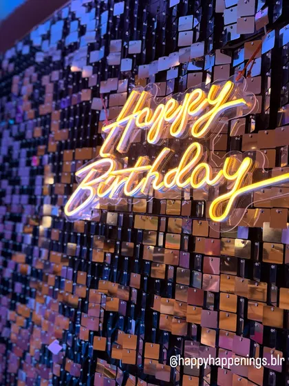 There's nothing like the sparkle of a shimmer wall. Here is a close-up of a custom neon sign against a gold sequin backdrop, creating a warm, inviting glow that makes any celebration feel extra special. This is a fantastic option for an anniversary or milestone birthday party.