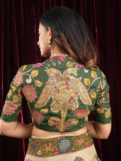The beauty of a saree is often in the details of its blouse. This is a closer look at the exquisite hand-painted work on one of my Pen Kalamkari blouses. The intricate peacock motif on the back makes it a statement piece that can elevate any saree.