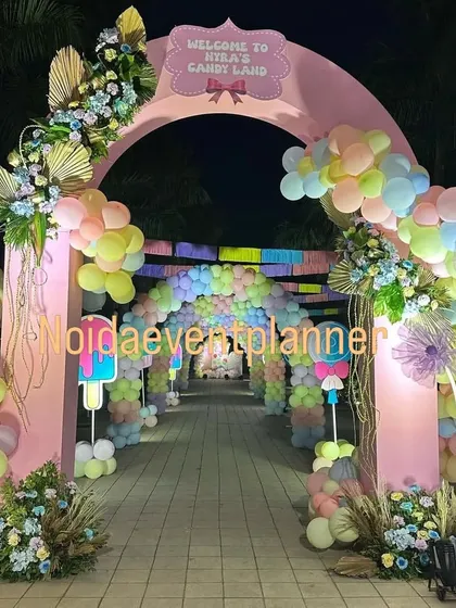 Welcome to Candyland! This sweet-themed party entrance features a pastel balloon tunnel, large candy props, and a custom welcome arch, setting a playful tone for the event.
