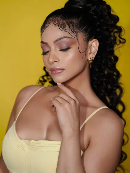 A serene portrait of the model, with her eyes closed to show off the beautiful yellow and brown eyeshadow blend.