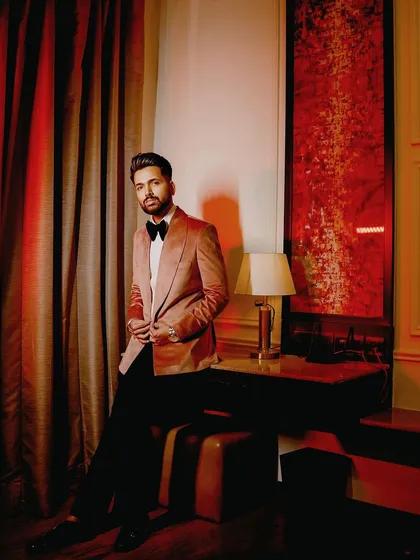 A portrait of Mr. Mudgal in his bespoke pink tuxedo, a modern and stylish choice for a groom.