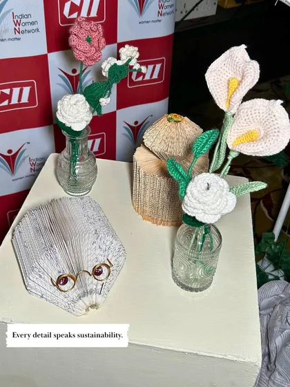 Every detail can speak to sustainability. For this eco-conscious event, the centerpieces featured handmade crochet flowers and whimsical sculptures crafted from folded book pages, adding a unique and mindful touch.