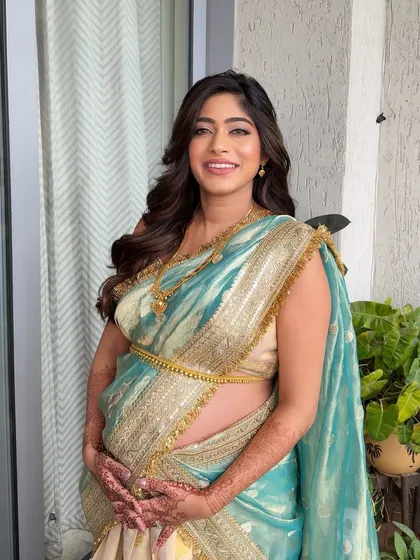A radiant mother-to-be with her hair in soft waves for her baby shower. This style is comfortable, elegant, and perfect for celebrating such a special milestone.