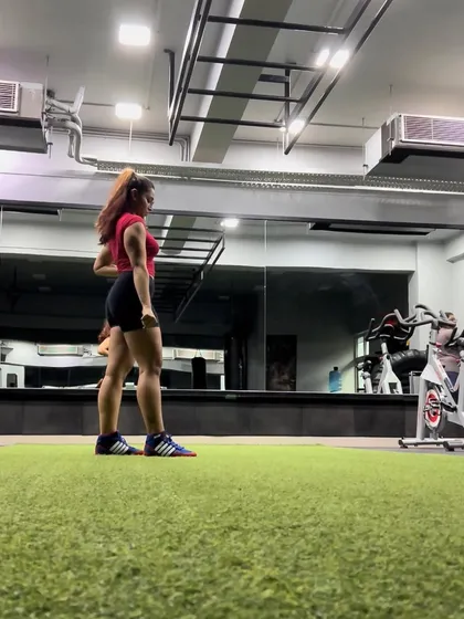 Posing on the turf at the gym. A look back at my physique and strength journey in 2022.