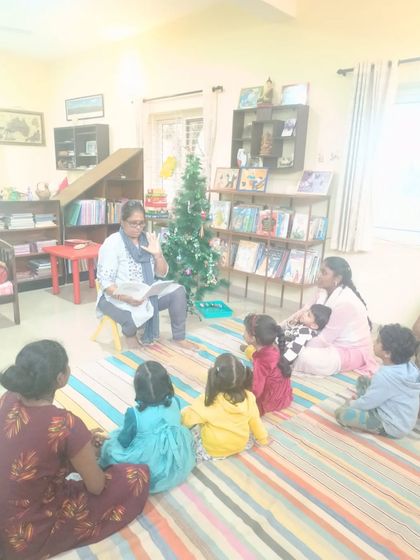 Another shot of the Christmas story, showing children captivated by the festive tale.
