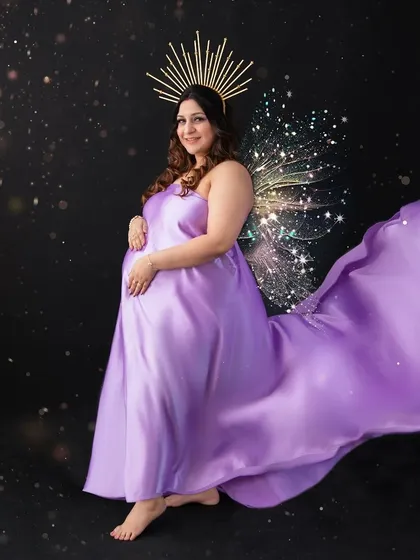 For the mother who wants to feel like a celestial goddess, I create portraits that are pure art. Using creative lighting and elegant styling, like this flowing satin gown and halo crown, I transform your maternity photo into a masterpiece that feels both powerful and magical.