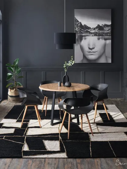 A great rug can be the centerpiece of a room. In this dramatic dining room setup, I used bold, graphic art and monochromatic tones to make the geometric rug the undeniable hero. This is an example of how I style a scene to ensure the product commands attention.