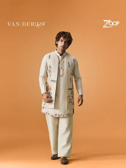 This off-white kurta set with a floral embroidered jacket has a timeless appeal. It blends classic charm with contemporary flair, making it suitable for any celebratory occasion.