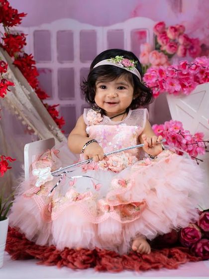 A beautiful fairy princess in a floral wonderland. The mix of pink and red flowers creates a vibrant and enchanting setting.