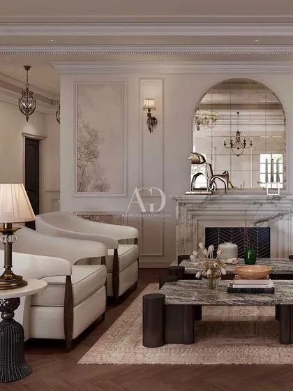 This seating area is arranged around a marble fireplace, creating a warm and inviting focal point. The arched mirror above the mantel reflects the room's light and architectural beauty, enhancing the sense of space and elegance.