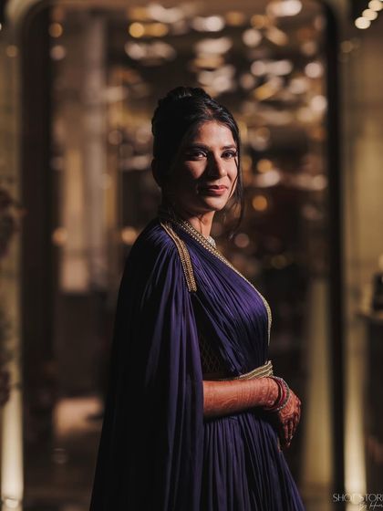 A portrait of my client in her Sufi night outfit. The elegant updo and classic jewelry perfectly complement the dramatic cape of her gown.