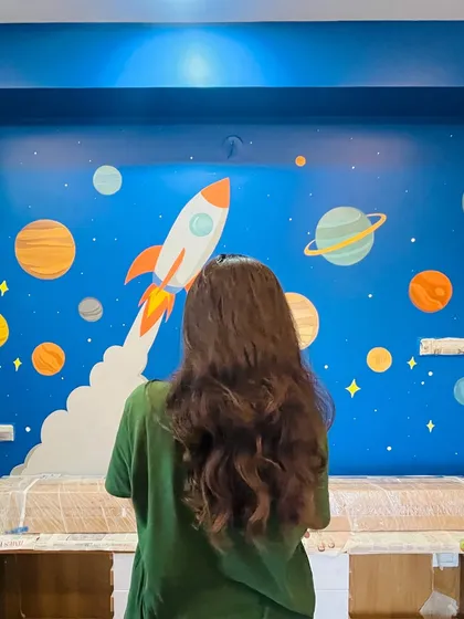 A final look at the completed solar system mural before the room is fully furnished. The vibrant colors and fun design make this a perfect feature wall for a kid's bedroom.
