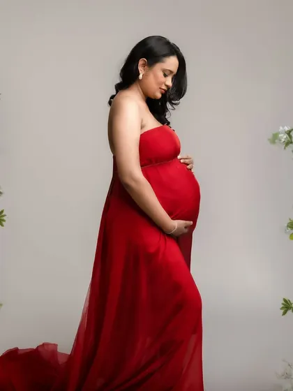 Framed by delicate white blossoms, this portrait in a red gown feels both passionate and pure.