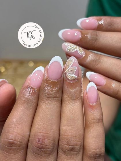 A classic bridal choice with a touch of sparkle. This set features a clean French manicure with a hand-painted, textured gold butterfly on the accent nail.