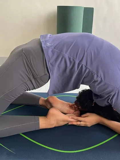 A student holding a deep Kapotasana. Notice the engagement of the legs and the lift in the chest, which are crucial for supporting the spine in this intense backbend.