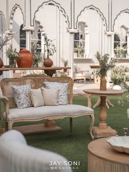 A comfortable and stylish seating group in the foreground, featuring a mix of modern and classic furniture pieces that complement the overall ivory theme.
