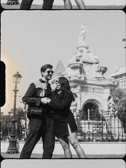 A classic pose with a vintage film border effect. This shot in front of a Mumbai landmark feels both nostalgic and romantic.