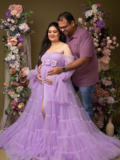 A protective and loving embrace. This pose showcases the couple's unity and shared joy, with both parents' hands cradling the baby bump.
