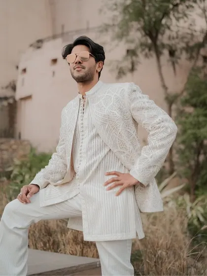 For Dulquer Salmaan, we created this regal all-white look with designer Faraz Manan. The outfit features a beautifully embroidered jacket over a striped kurta, showcasing my approach to layered, textured, and sophisticated ethnic menswear.