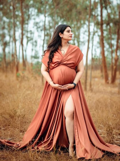 This beautiful mom-to-be looks so serene in her flowing terracotta gown. The natural, rustic setting provides a perfect contrast to the elegant dress.