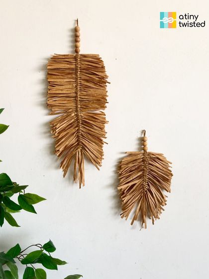 These simple, elegant raffia feather hangings are perfect for adding a light, airy, and natural touch to your walls. They can be hung alone or as part of a larger gallery wall.