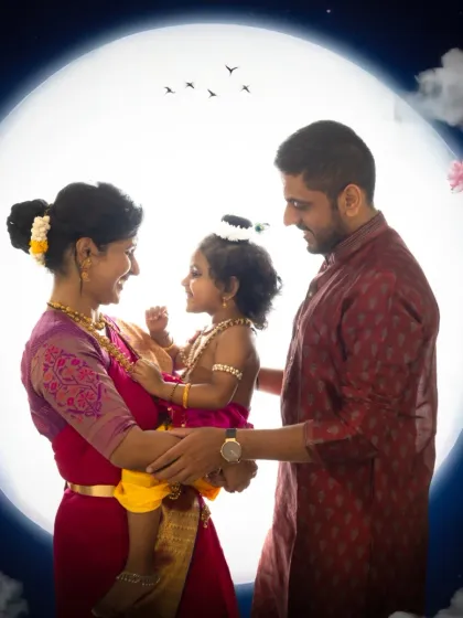 A complete family portrait within the magical Yashoda Krishna theme. The full moon backdrop adds a dreamy, celestial feel to this beautiful moment shared between parents and their little one.